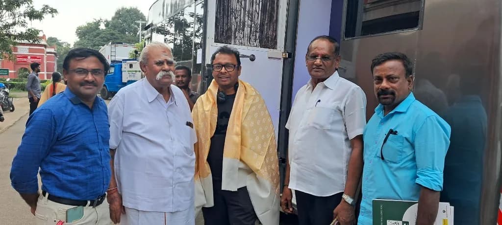 AirMedia team with a celebrity guest draped in a ceremonial shawl outdoors